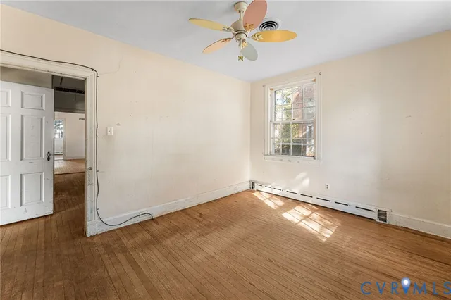 wooden floor in an empty room with a window