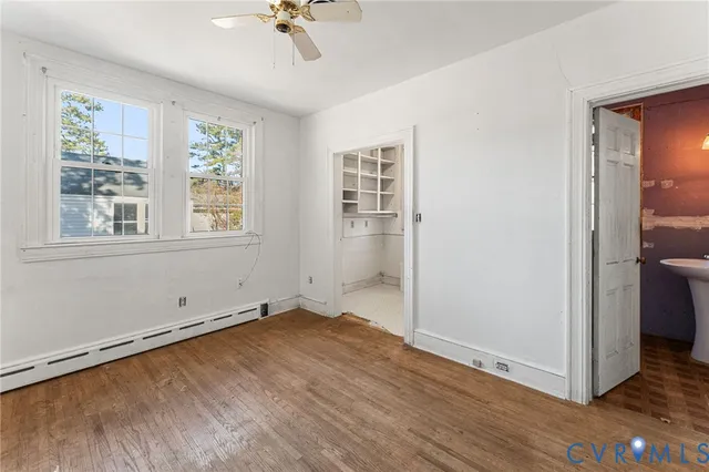wooden floor in an empty room with a window