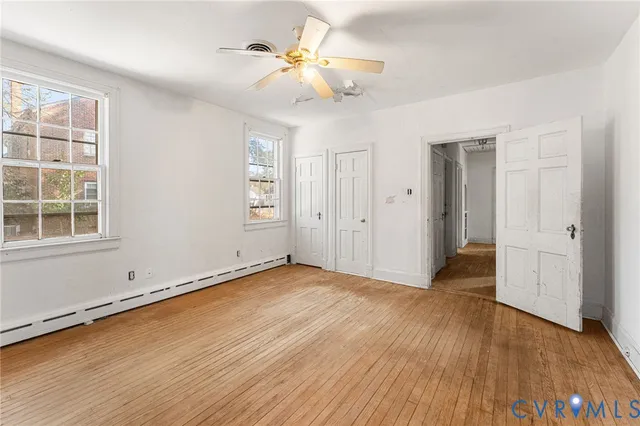 wooden floor in an empty room with a window