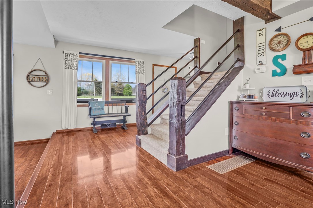 39233 Jones Road Litchfield, OH 44253 - Photo 8 of 46 Staircase featuring baseboards and wood finished floors