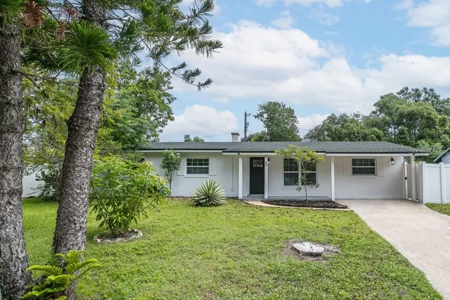 a front view of house with yard and green space