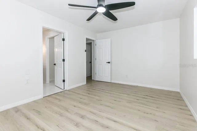 a view of empty room with wooden floor