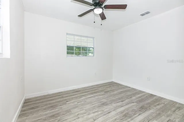 a view of an empty room with windows and a big room