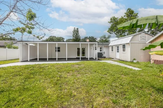 a front view of a house with a garden and plants