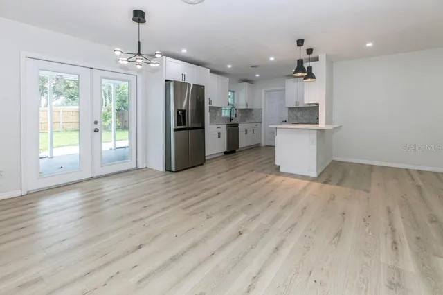 a view of a kitchen with a sink and wooden floor