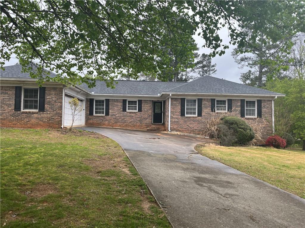 1709 Elizabeth Court Southwest Conyers, GA 30094 - Photo 1 of 1 a front view of house with yard and green space