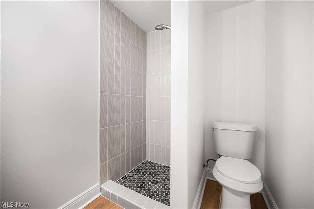 28300 Aurora Road Solon, OH 44139 - Photo 31 of 36 Walk-in shower with vertical subway tile surround, hexagonal tile flooring, and a chrome shower head