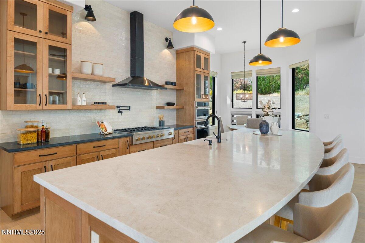10755 Renegade Court Reno, NV 89511 - Photo 13 of 60 a kitchen with stainless steel appliances granite countertop a sink a stove and a wooden floors