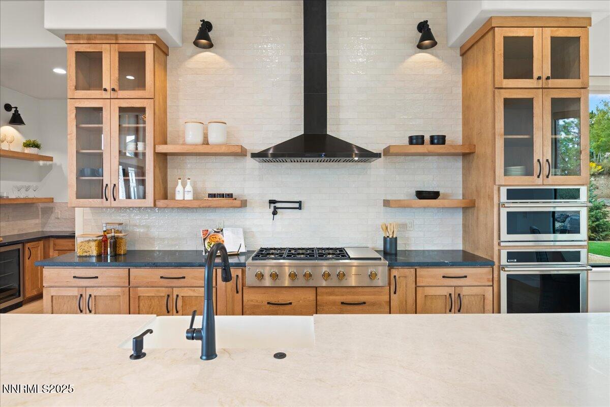10755 Renegade Court Reno, NV 89511 - Photo 14 of 60 a kitchen with stainless steel appliances kitchen island granite countertop a sink and cabinets