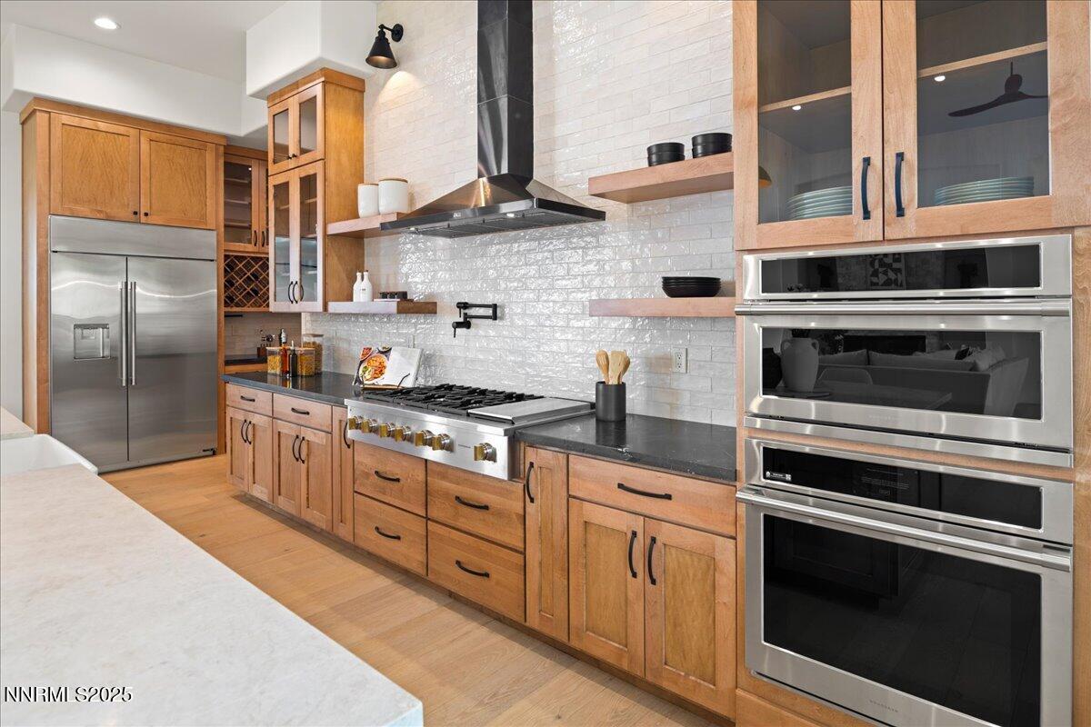 10755 Renegade Court Reno, NV 89511 - Photo 15 of 60 a kitchen with stainless steel appliances granite countertop a stove and a refrigerator