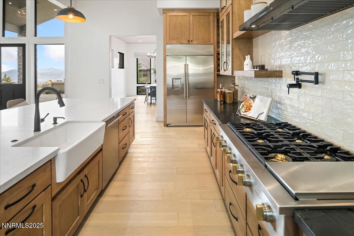 10755 Renegade Court Reno, NV 89511 - Photo 16 of 60 a kitchen with stainless steel appliances granite countertop a stove and a refrigerator