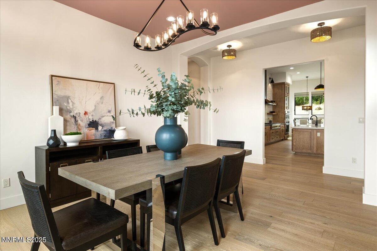 10755 Renegade Court Reno, NV 89511 - Photo 23 of 60 a view of a dining room with furniture and wooden floor