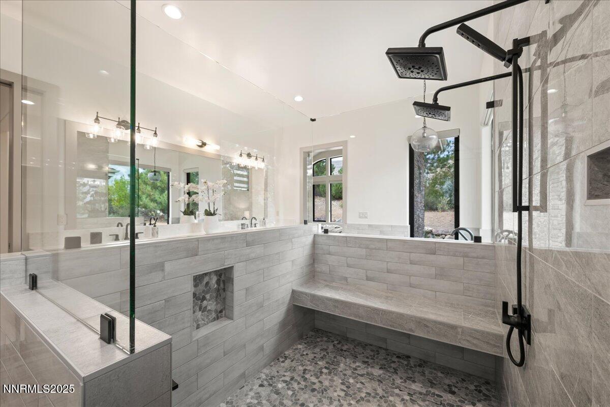 10755 Renegade Court Reno, NV 89511 - Photo 31 of 60 a bathroom with a tub sink and glass door