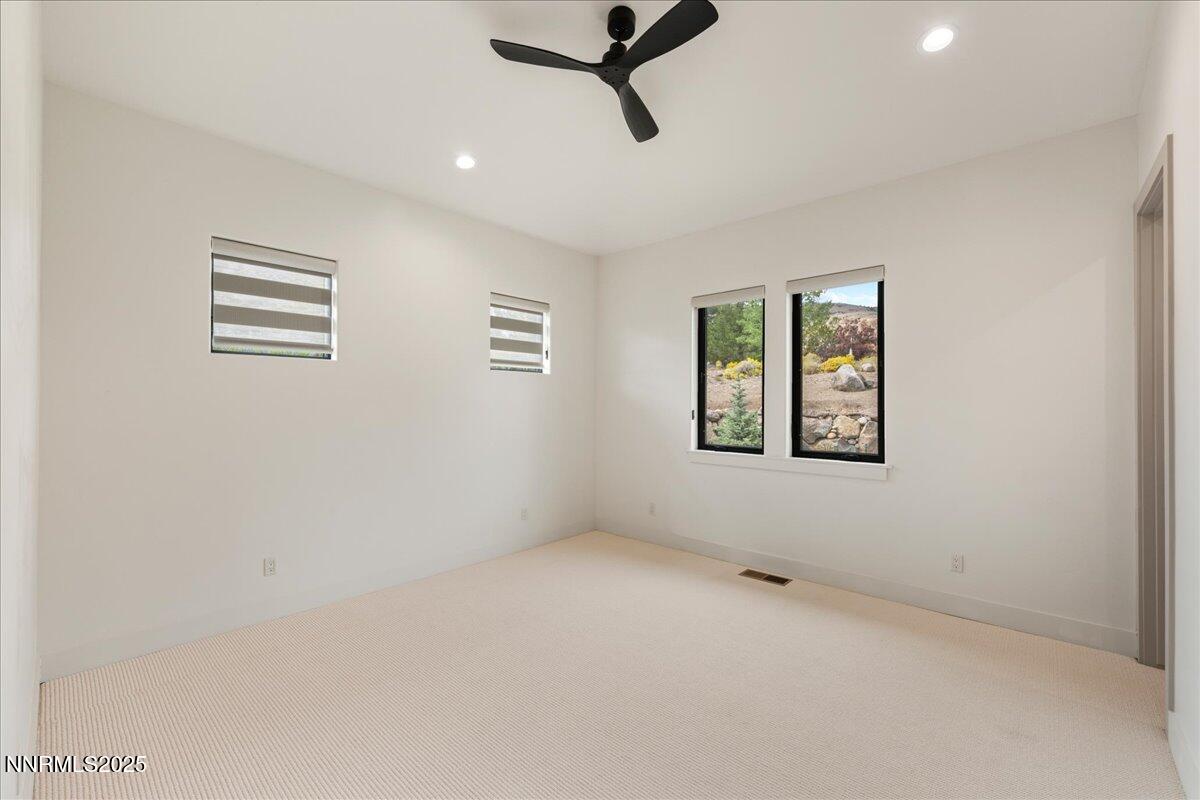 10755 Renegade Court Reno, NV 89511 - Photo 38 of 60 an empty room with windows and cabinet