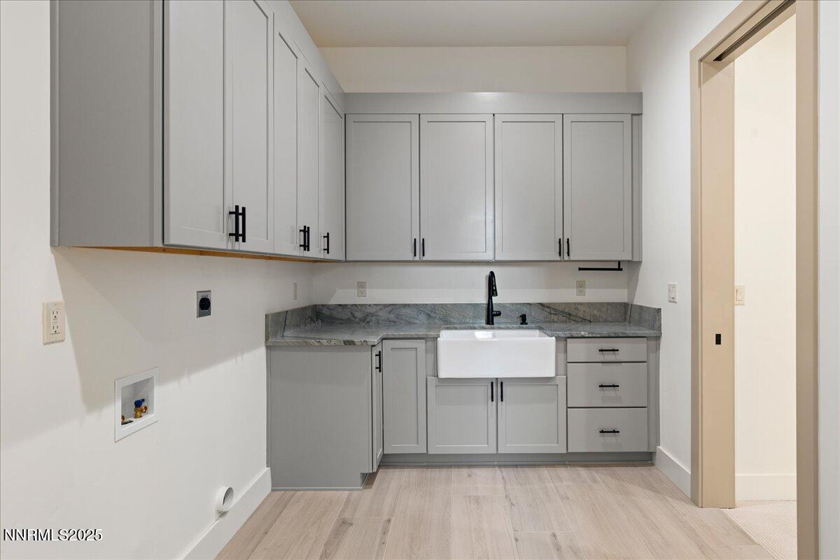 10755 Renegade Court Reno, NV 89511 - Photo 42 of 60 a kitchen with stainless steel appliances granite countertop a sink and cabinets with wooden floor