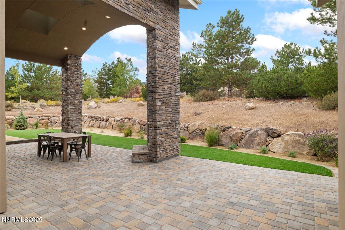 10755 Renegade Court Reno, NV 89511 - Photo 57 of 60 a view of a patio with a table and chairs under an umbrella