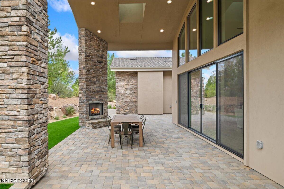 10755 Renegade Court Reno, NV 89511 - Photo 58 of 60 a patio with a table and chairs and potted plants