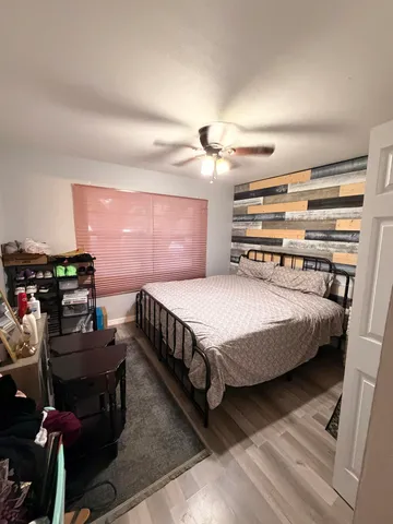 a bathroom with a granite countertop sink toilet a mirror and shower