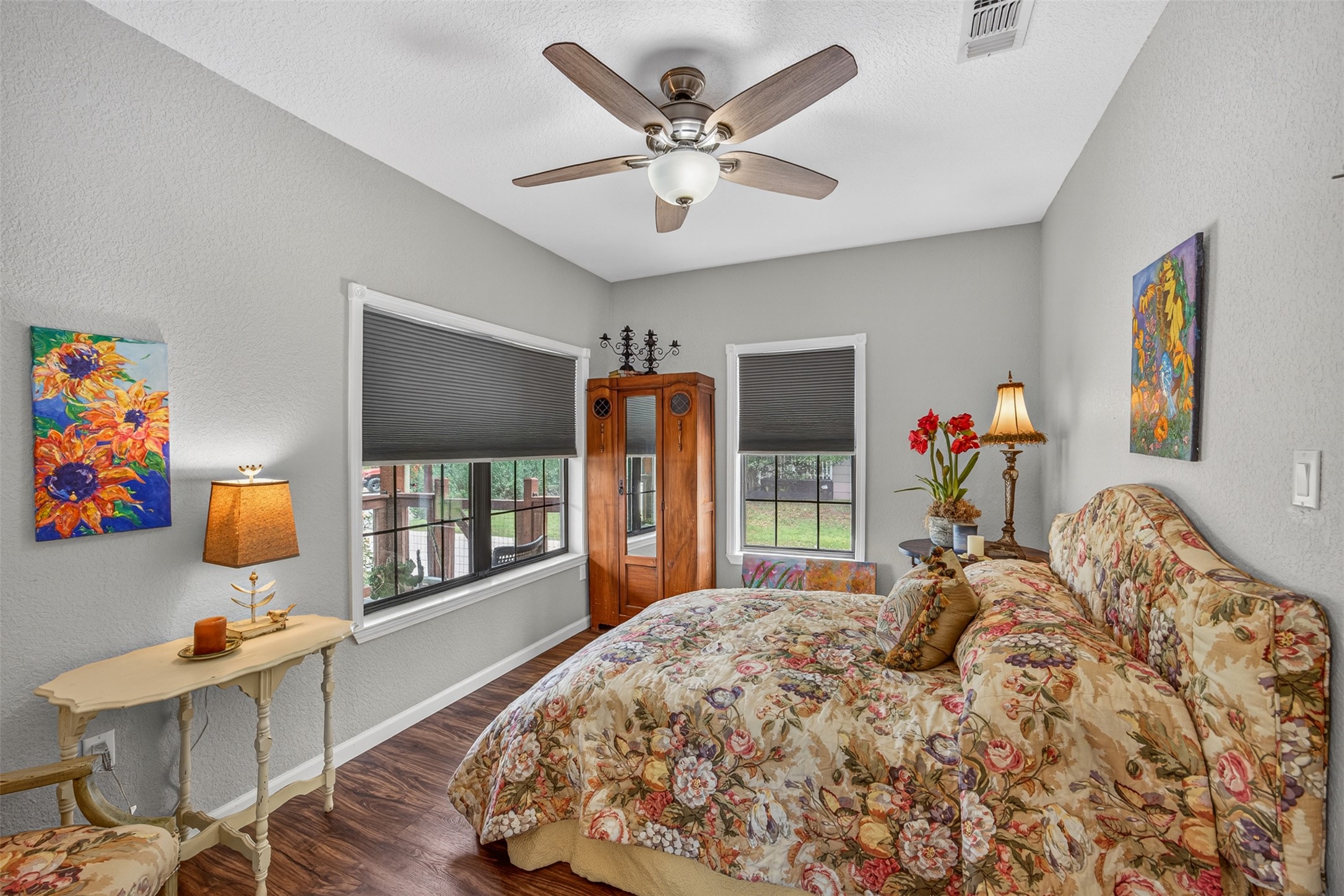 217 Walnut Avenue Luling, TX 78648 - Photo 18 of 38 a bedroom with a bed painting on wall and a large window