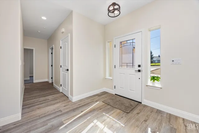 a view of a kitchen with furniture and wooden floor