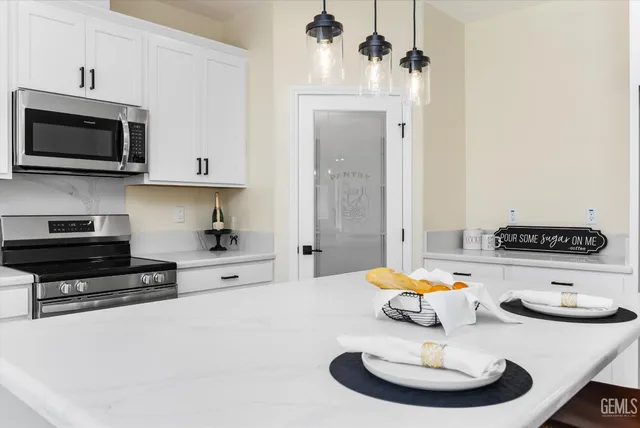 a kitchen with stainless steel appliances a stove sink and cabinets