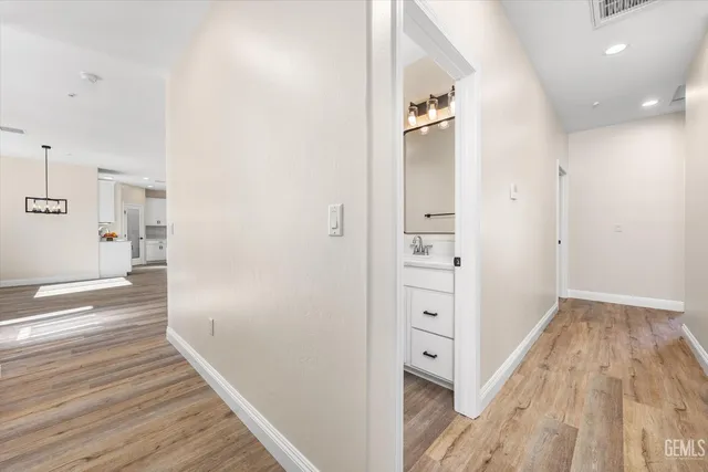 an empty room with window and ceiling fan