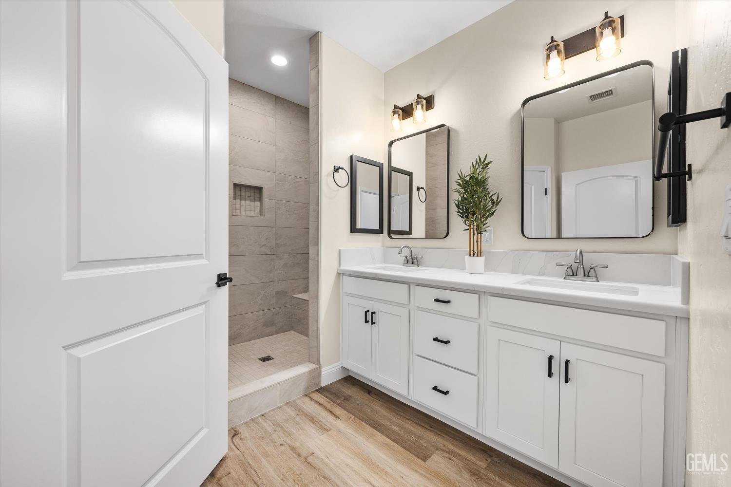 Undisclosed Address Tehachapi, CA 93561 - Photo 34 of 50 a spacious bathroom with double vanity a double vanity sink a mirror and a bathtub