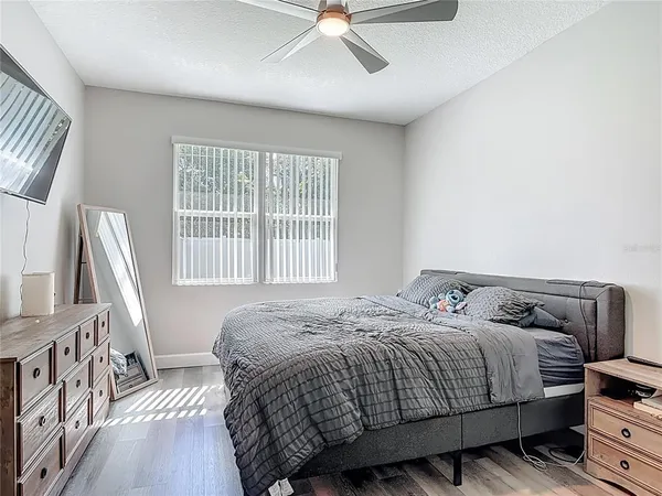 a bedroom with a bed and wooden floor