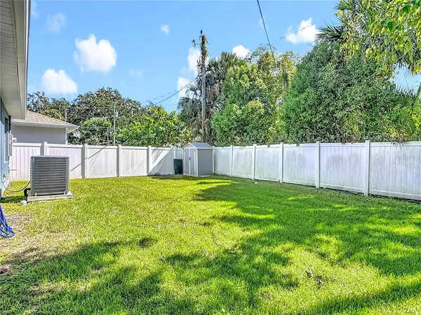 a view of a swimming pool with an outdoor seating and a yard