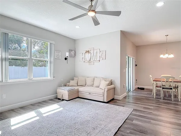 a living room with furniture and kitchen view