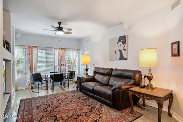 a living room with furniture ceiling fan and a rug