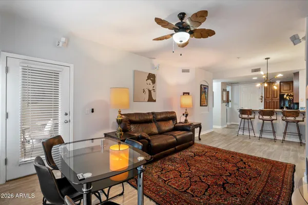a living room with furniture a table and a chandelier