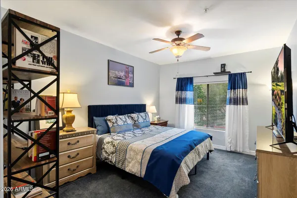 a bedroom with a bed and a chandelier