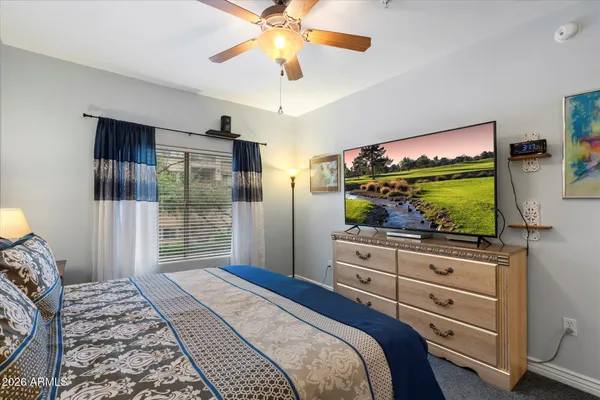 a bedroom with a bed and a flat screen tv