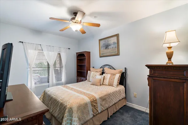 a bedroom with a large bed and a chandelier