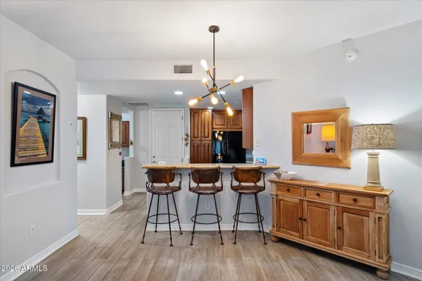 a view of a dining room and chairs with wooden floor