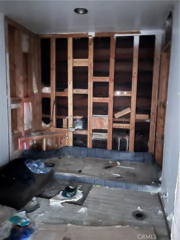 a living room with furniture windows and kitchen view