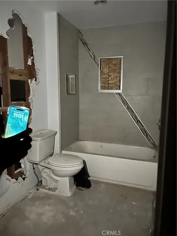 a bathroom with a toilet a sink and a bathtub