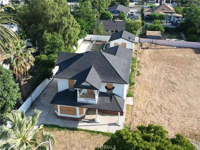 an aerial view of a house with swimming pool and garden