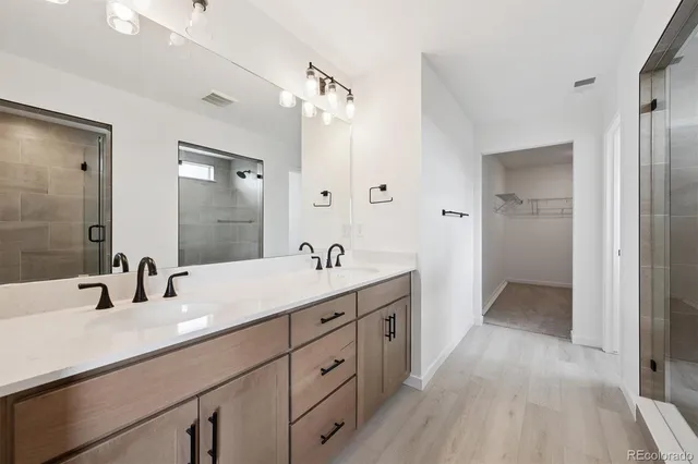 a bathroom with a double vanity sink and mirror