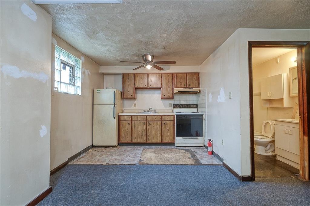327 Helen Street McKees Rocks, PA 15136 - Photo 8 of 14 a kitchen with a sink refrigerator and cabinets
