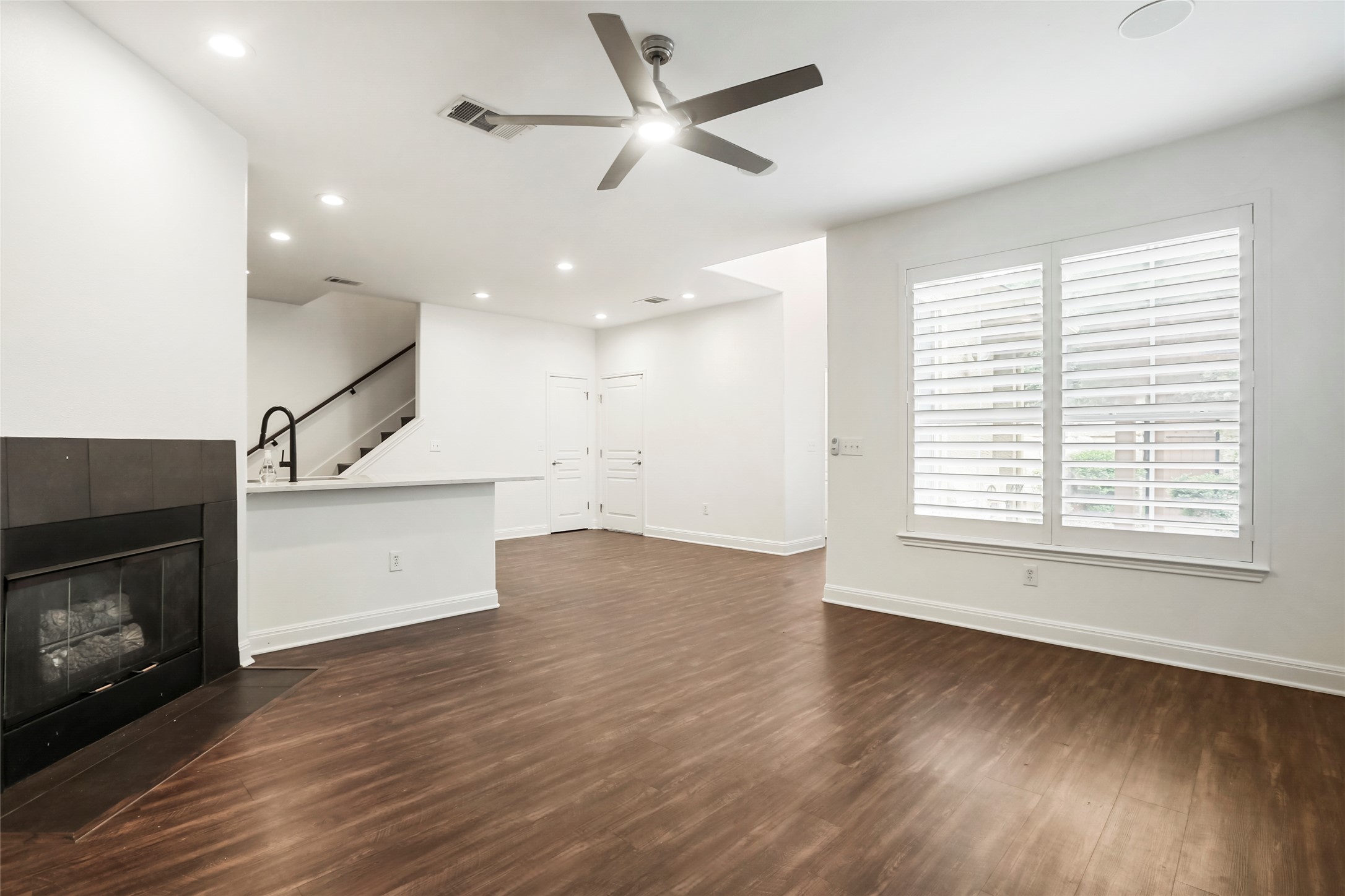 3406 Menchaca Road, Unit 19 Austin, TX 78704 - Photo 5 of 25 Rich wood flooring anchors this open living space illuminated by recessed lighting.