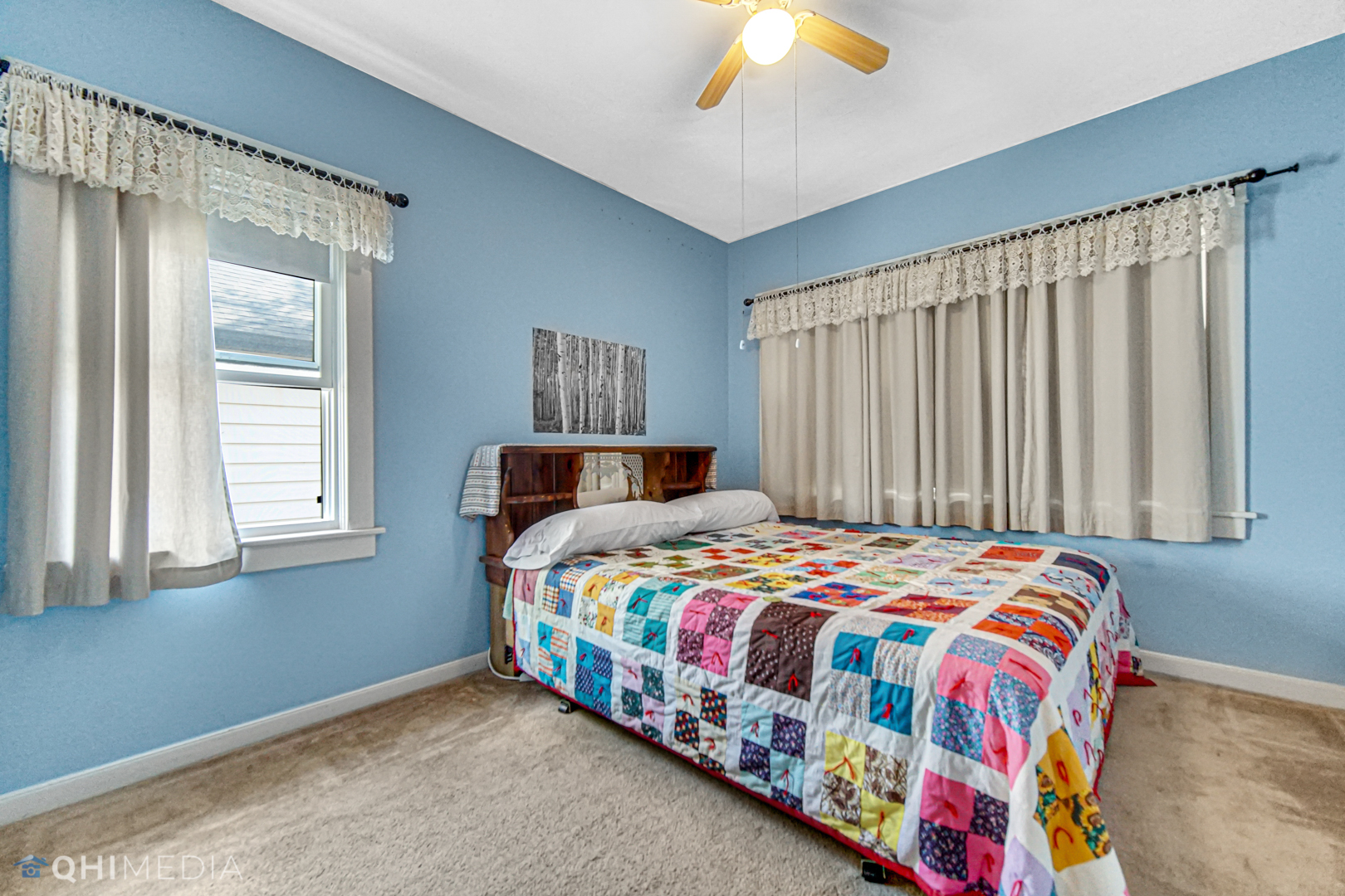 520 North Reed Street Joliet, IL 60435 - Photo 17 of 23 a bedroom with a bed and a chandelier