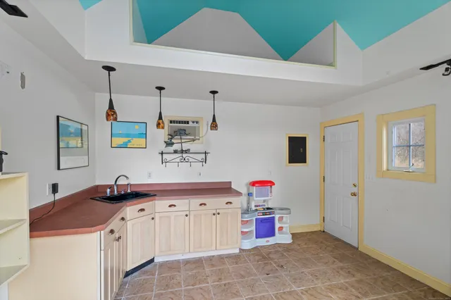 a view of a living room with wooden floor and a large window