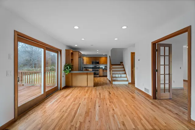 a view of a livingroom with wooden floor a fireplace and window