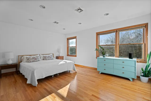 a bedroom with a bed and a potted plant