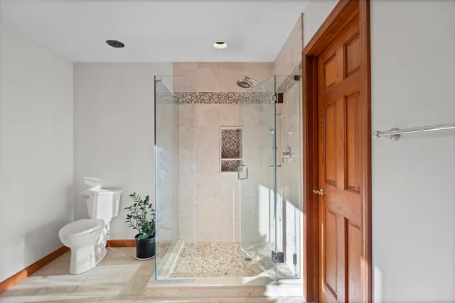 a spacious bathroom with a granite countertop tub sink and mirror