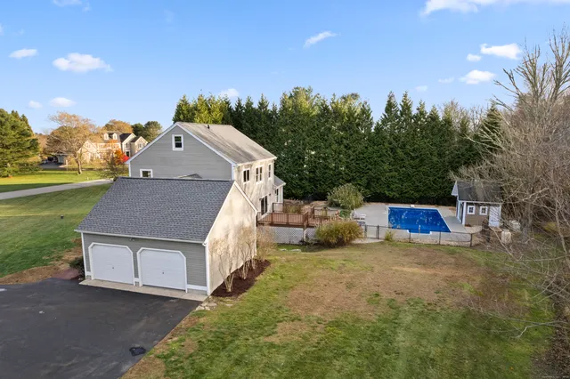 a kitchen with stainless steel appliances granite countertop a refrigerator a sink dishwasher a stove with wooden cabinets and floor