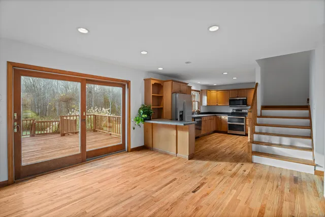 an aerial view of a house with garden space and ocean view