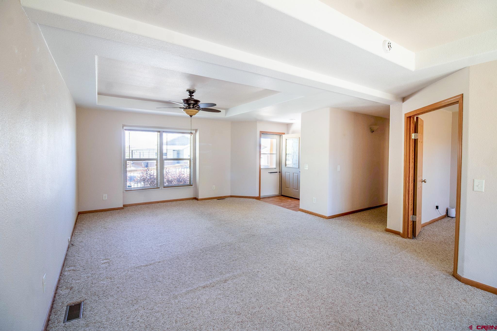 801 L Way Cortez, CO 81321 - Photo 12 of 41 an empty room with windows and ceiling fan